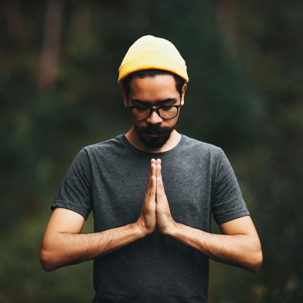 Man meditating in a calm, focused environment.